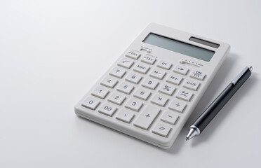 A calculator and pen on a white background
