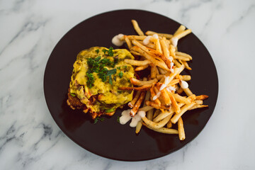plant-based food, vegan parmigiana with plant-based schnitzel dairy-free cheese and french fries