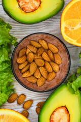 fresh vegetables and fruits, avocado, orange, lettuce, almonds, healthy and vegan food, diet concept, detox, body weight control, products for immunity