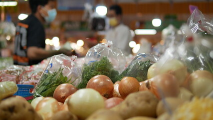 Blurred background of marketplace in Bangkok, People shopping fresh vegetables in market,  consumerism and people concept
