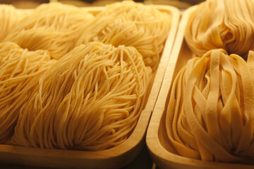 Homemade pasta process. Finished pasta on refrigerator.