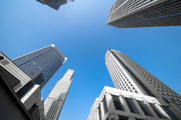 Fototapeta na wymiar Low angle shot of modern glass city buildings with clear sky background.
