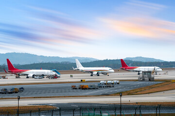 Airport with many airplanes at beautiful sunset