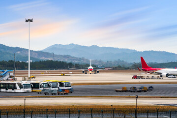 Fototapeta na wymiar Airport with many airplanes at beautiful sunset