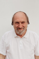 Stock Photo - Senior man in a white t-shirt wearing medical mask
