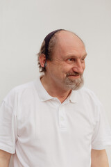 Stock Photo - Senior man in a white t-shirt wearing medical mask