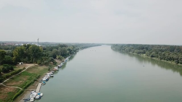 A drone view of a river in Brcko under a cloudy sky in Bosnia and Herzegovina shot in HD