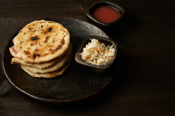 Traditional salvadoran breakfast and dinner, corn tortillas filled with pork, cheese and beans, pupusas