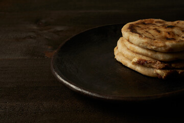 Traditional salvadoran breakfast and dinner, corn tortillas filled with pork, cheese and beans, pupusas