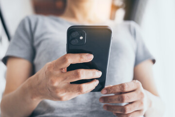 using cell phone hand holding mobile texting message contact us.chatting,search internet information in office.technology device communication connecting