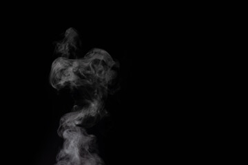 Figured smoke on a dark background. Abstract background, design element, for overlay on pictures.