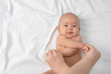 Masseur giving massage to smiling newborn