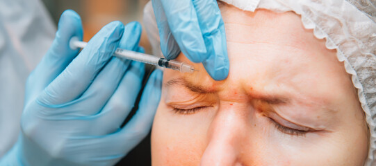 Senior woman getting skin care injection, close up. Platelet Rich Plasma for reducing face...