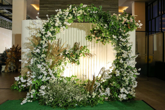 Beautiful photo booth zone at wedding or birthday reception. holiday photobooth decor with flowers, and lights