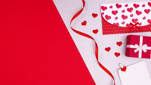 Happy Valentine's dat envelope, gift and ribbons appear on right side. Stop motion