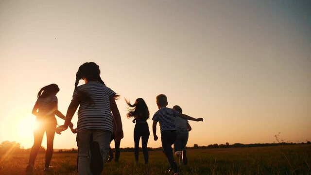 happy family children kid together run in the park at sunset silhouette. people in the park concept. happy family joyful run. happy family and little fun baby child summer kid dream concept