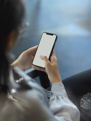 Businesswoman using smartphone while sitting in office room