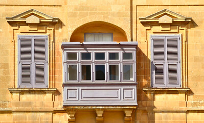 Fototapeta na wymiar Traditional wooden colorful balconies in center of La Valletta. Malta