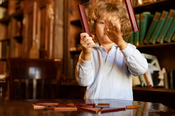 little child is playing with a toy at home