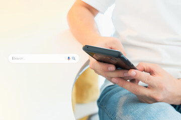 SEO Technology and digital lifestyle concept. Close up of a young man's hands sitting, typing, searching and reading social media on smartphone. Selective focus.