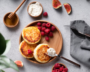 Cottage cheese pancakes with raspberries and honey top view