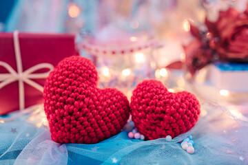 heart shape, Foam beads, feather, gift box and light decorative bokeh on blue cloth. Love, Valentine and holiday concept.