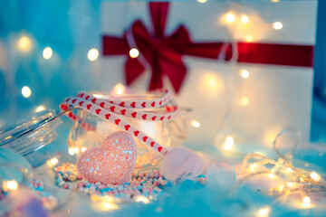 heart shape, Foam beads, feather, gift box and light decorative bokeh on blue cloth. Love, Valentine and holiday concept.