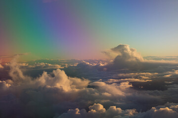 spectacular sunset seen from an airplane with clouds in the foreground and in the distance
