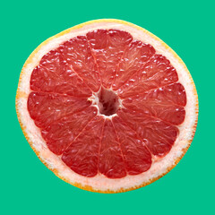 red grapefruit lies on a red background