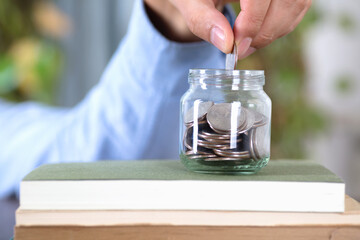 Put the dollar coin into the glass bottle on the book