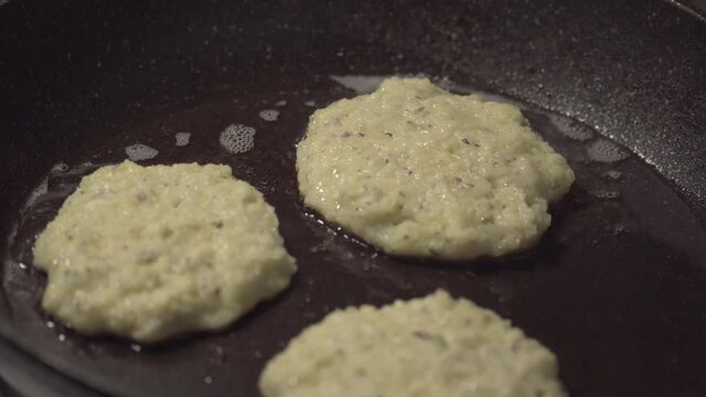 Drank, potato pancakes are fried in a pan. Russian traditional food