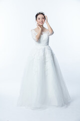 Fototapeta na wymiar Beautiful asian woman dressed as a bride on white background