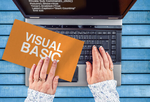 Visual Basic programming language. Paper width words Visual Basic and laptop