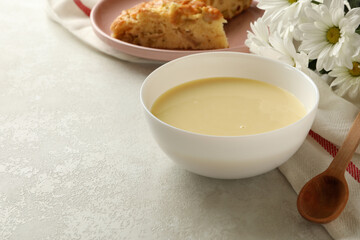 Concept of tasty lunch with bowl of condensed milk