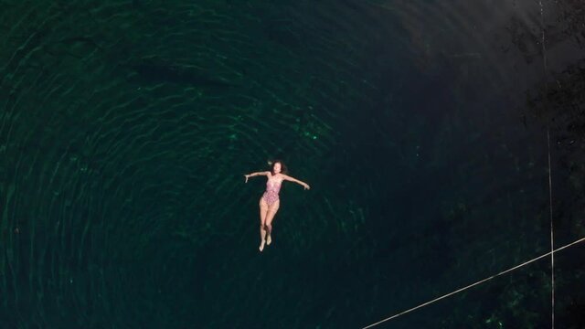 Relaxed woman floating on water in lake