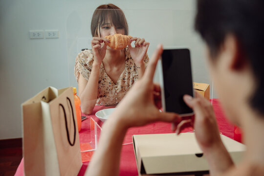 Asian Couple Eating Food At Restaurant During Covid-19 Outbreak.