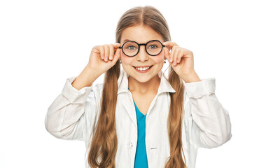 Portrait of smiling cute girl wearing eyeglasses and medical coat. Child vision treatment choosing glasses over white background