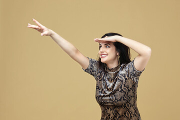 charming brunette pulls her hand and looks in amazement in front of her