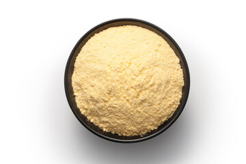 Corn flour in a black bowl isolated on white background. Top view.