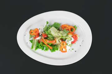 a plate of delicious salad on a black background