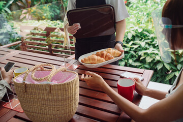 Couple eating food at restaurant during covid-19 outbreak.