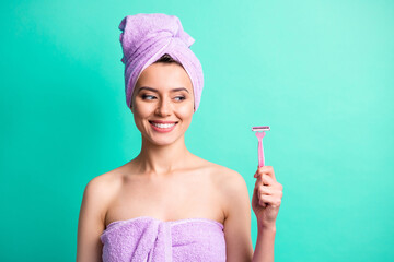 Photo of lovely young girl hold look razor wear violet towel turban isolated turquoise color...