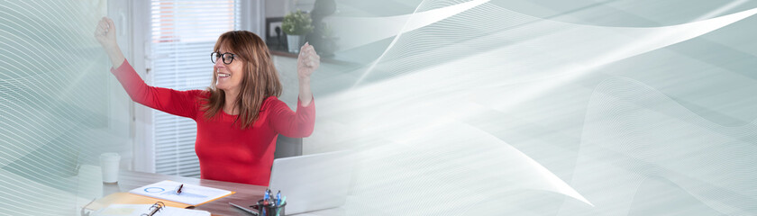 Successful mature businesswoman with arms up; panoramic banner