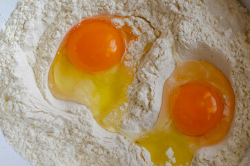 Raw chicken eggs and flour.