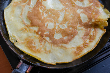 Blini, Shrovetide. Cooking traditional homemade crepes.