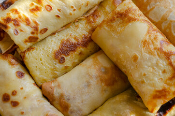 Blini, Shrovetide. Close-up of traditional homemade crepes stuffed with various fillings.