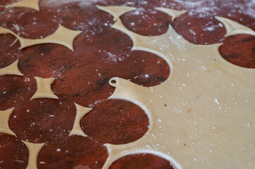 Thinly rolled raw dough for dumplings on the kitchen table.