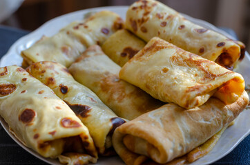 Blini, Shrovetide. Close-up of traditional homemade crepes stuffed with various fillings.