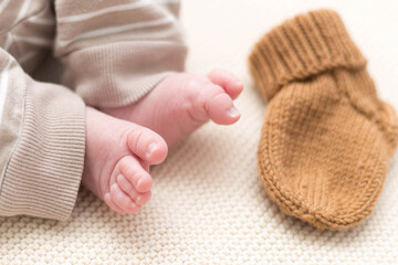 legs of a newborn on a light background, baby