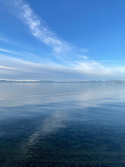 Vertical view of clouds reflected in the calm blue waters of Lake Tahoe